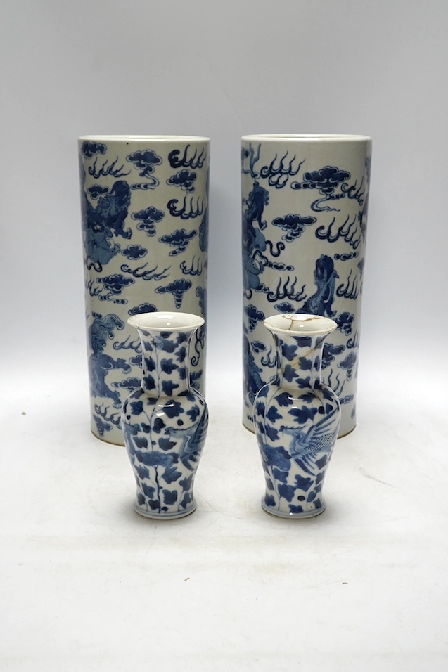A pair of Chinese blue and white cylindrical brushpots and a smaller pair, tallest 29cm. Condition - both smaller vases with heavy repairs
